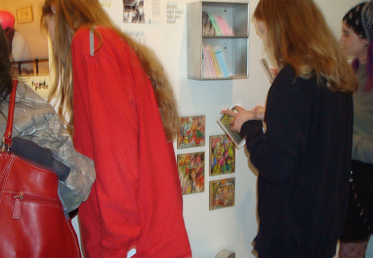 group of people reading zines at my senior exhibit